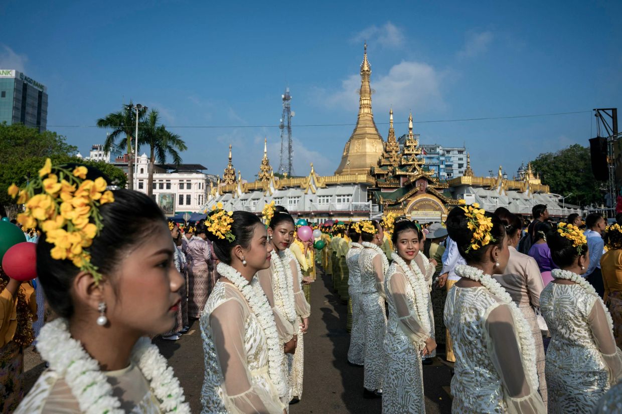 Performers in traditional costumes prepare to perform during celebrations for Myanmar's Buddhist New Year festival, also known as Thingyan, in Yangon on Monday, April 13, 2026. --Photo by Sai Aung MAIN / AFP