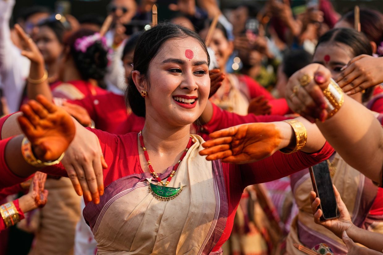 Assamese girls wearing traditional Mekhela Chadar perform the Bihu folk dance during the Rongali Bihu festival, organised by All Assam Students Union in Guwahati, capital of the north eastern state of Assam, in Guwahati, India, on Tuesday, April 14, 2026. -- AP Photo/Anupam Nath