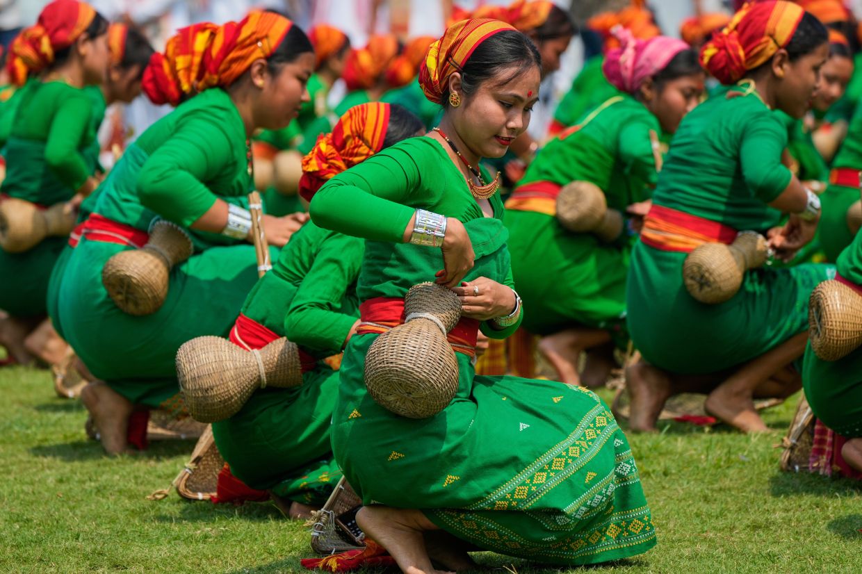 Sonowal Kochari tribal girls wearing traditional attire perform their folk fishing dance during the Rongali Bihu festival, organized by All Assam Students Union in Guwahati, capital of the north eastern state of Assam, in Guwahati, India, on Tuesday, April 14, 2026. -- AP Photo/Anupam Nath