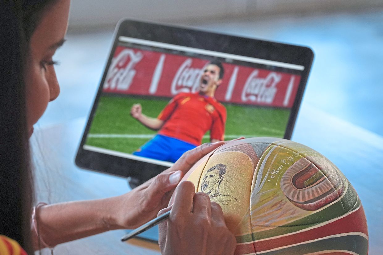 Some footballs take Cantero days to paint. Others take her just a couple of hours. Photo: AP