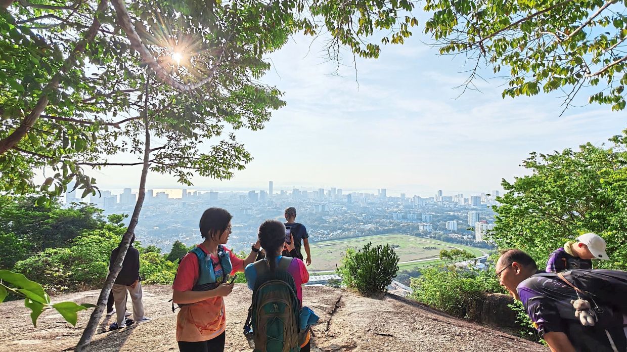 Hikers enjoying the sunrise during their trip to Astro Rock.