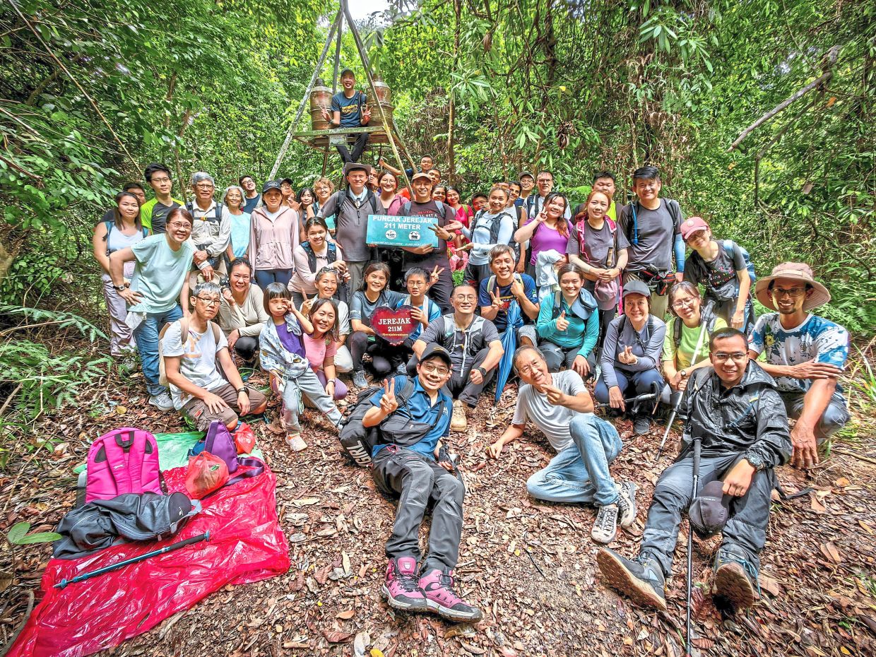 A group of hikers resting at the peak of a hill in Pulau Jerejak after exploring some of its historical sites. — Photos: LO TERN CHERN/The Star, courtesy photos and filephotos