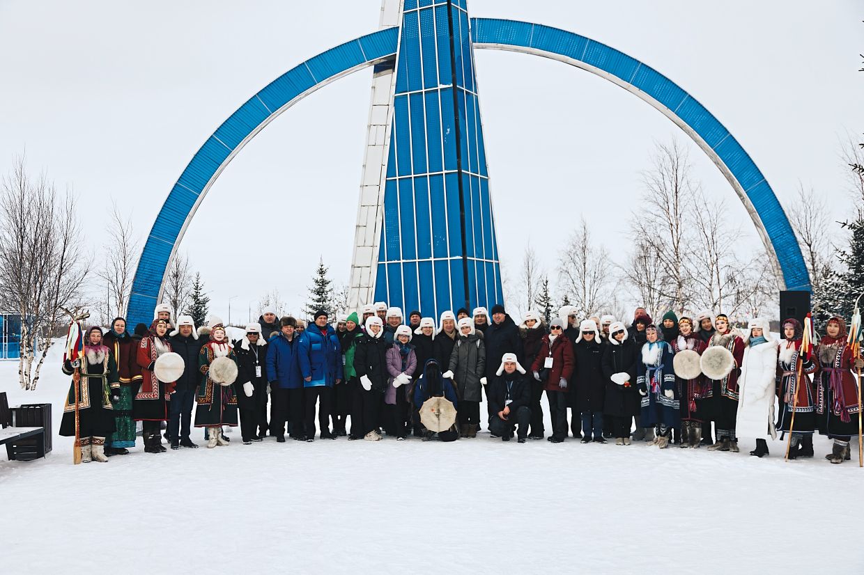 A group photo of the delegation after the Arctic Circle Crossing Ceremony at the 66th Parallel Stele.