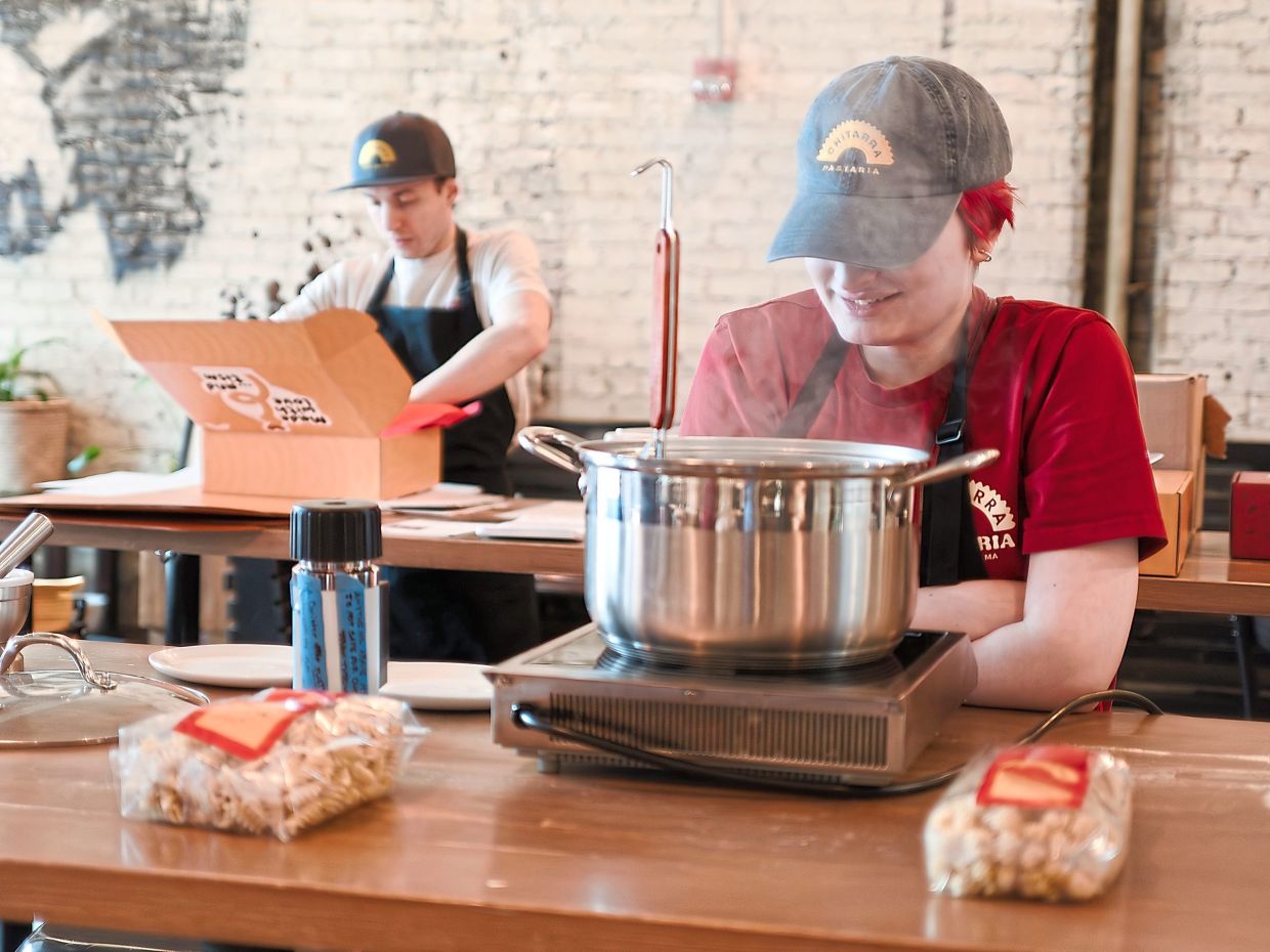 All eight employees of Chitarra Pastaria, a pasta maker are on the autism spectrum, including Stefano Micali (left) and Julia Agostino. Photos: DAVIS DEGNER/ The New York Times
