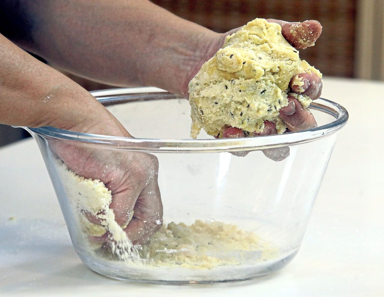 Lightly beat the egg and work it into the mixture by hand until a cohesive dough forms.