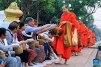 Laos continues centuries-old alms giving tradition