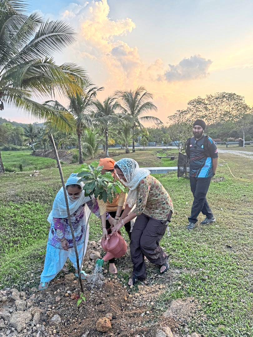 Participants planting fruit tree saplings at the International Sikh Centre @ Khalsa Land in Kuala Kubu Baru, Selangor.