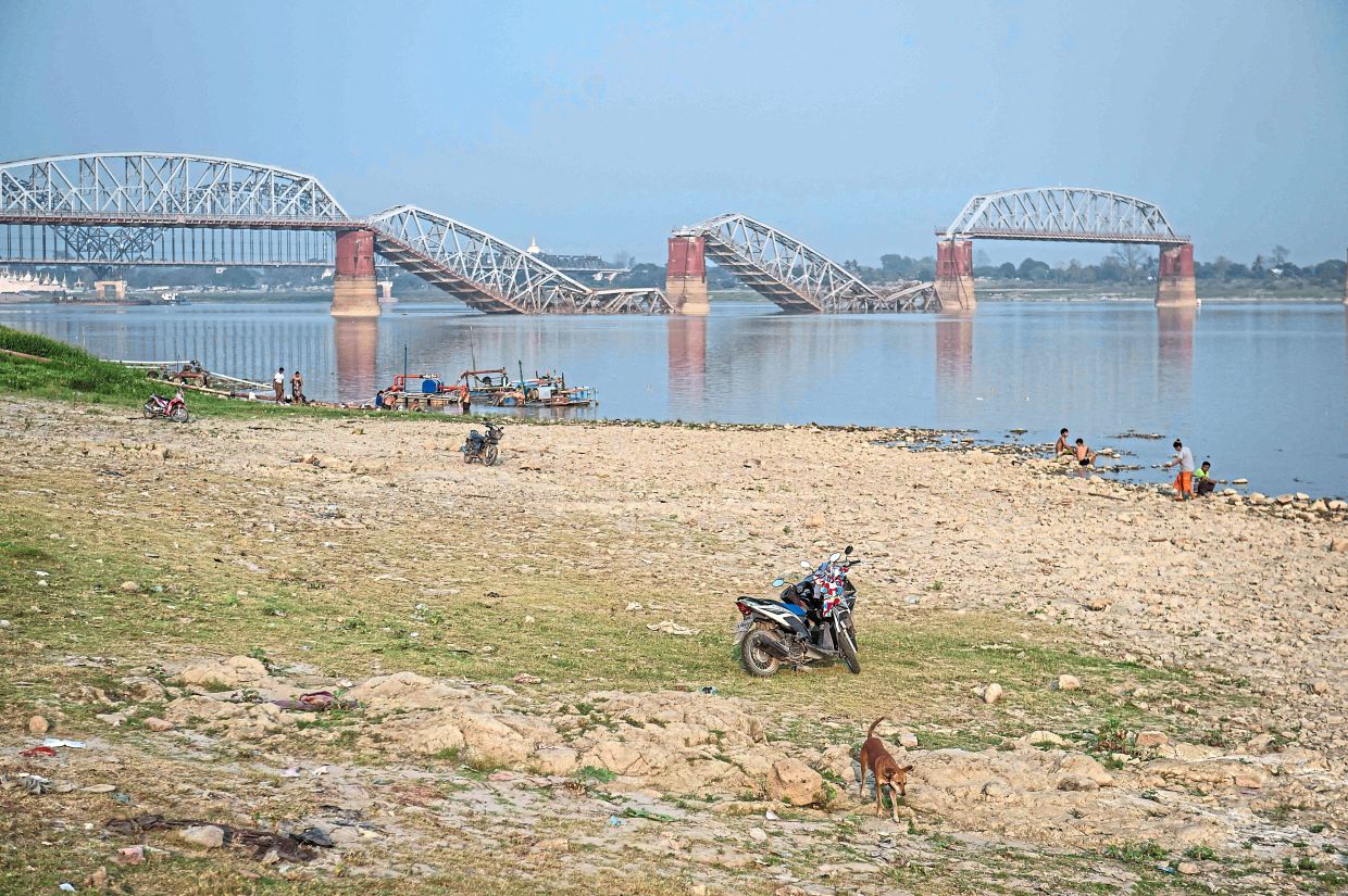 Collapsed landmark: The Irrawaddy River and the collapsed Ava Bridge, also known as the Iowa Bridge, in Sagaing. — AFP 