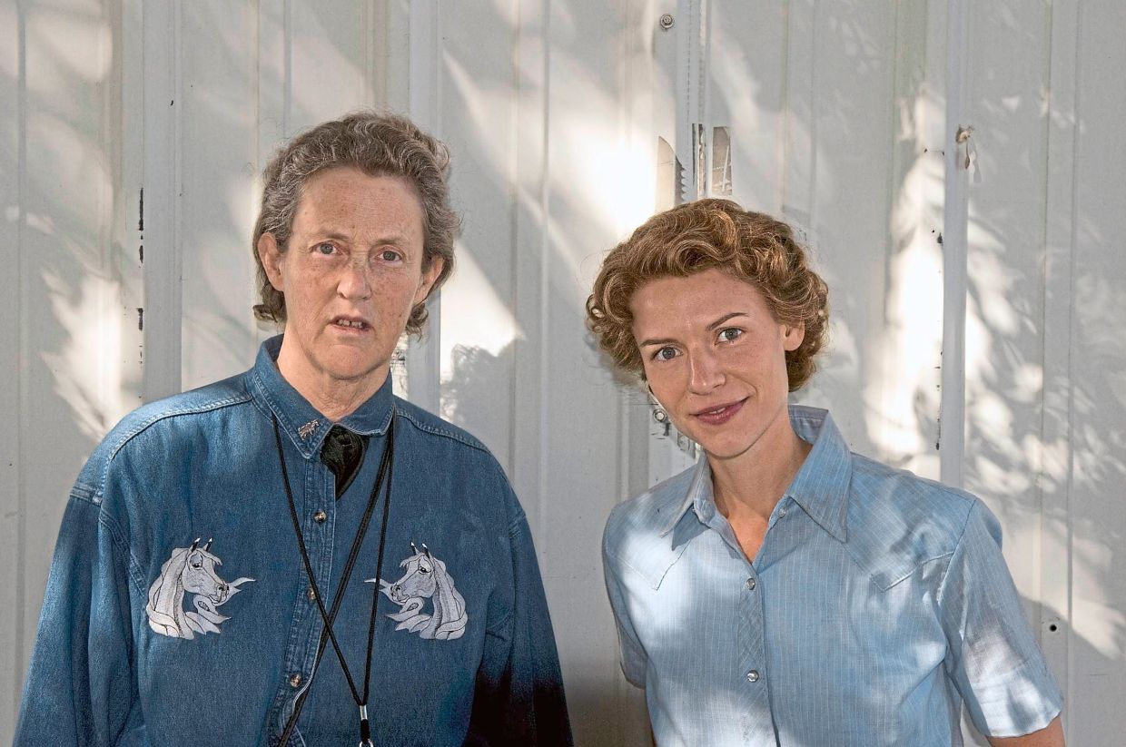 Danes (right) with Grandin, the woman she portrays in the movie, Temple Grandin. — Filepic