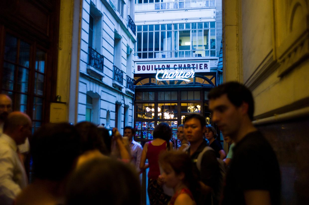 People queue to enter in the French brasserie Bouillon Chartier, on July 24, 2013 in Paris.