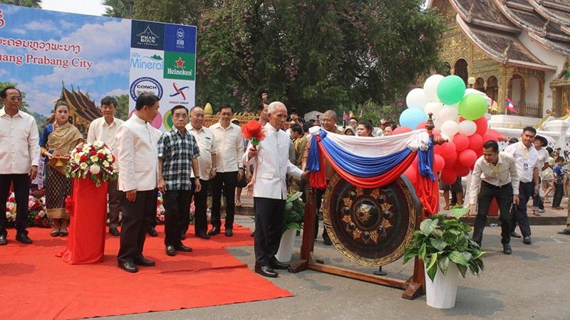 Politburo member and Head of the Commission for Information and Education of the Central Committee, Khamphan Pheuyavong, strikes a gong to mark the Lao New Year celebrations during the Hae Vor procession in Luang Prabang city on April 15.