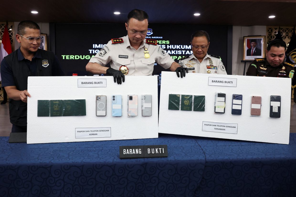 Immigration officials show evidence during a press conference following the arrest of three Pakistanis allegedly smuggling people to Australia in Jakarta, Indonesia, on Monday, April 20, 2026. -- REUTERS/Ajeng Dinar Ulfiana