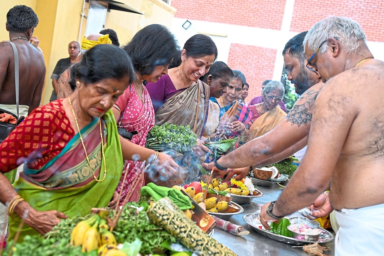 Worshippers preparing trays of offerings ahead of prayers for the Tamil New Year at Sri Sithi Vinayagar Temple, as the community comes together to mark the auspicious occasion. — IZZRAFIQ ALIAS/The Star