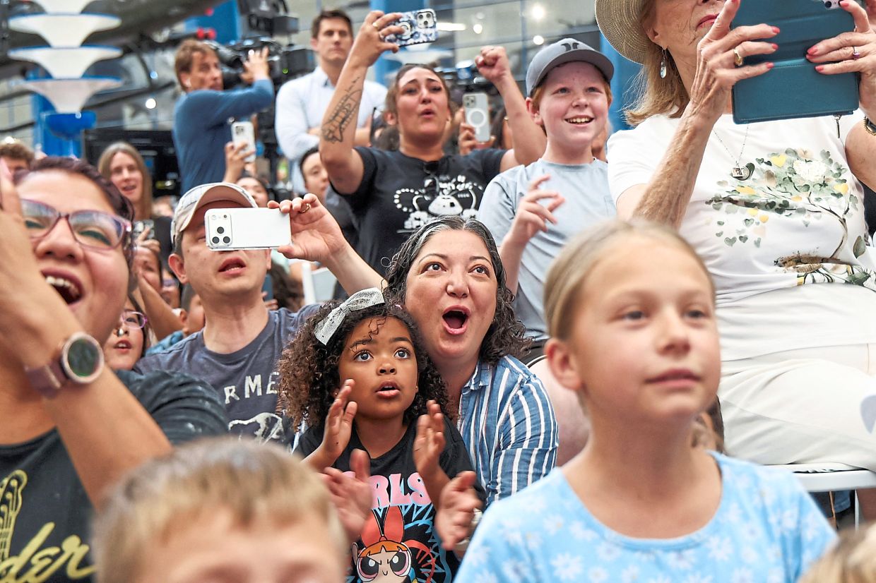 Spectators holding their breath as they watch the Artemis II Orion capsule splash down off the coast of California. — Reuters