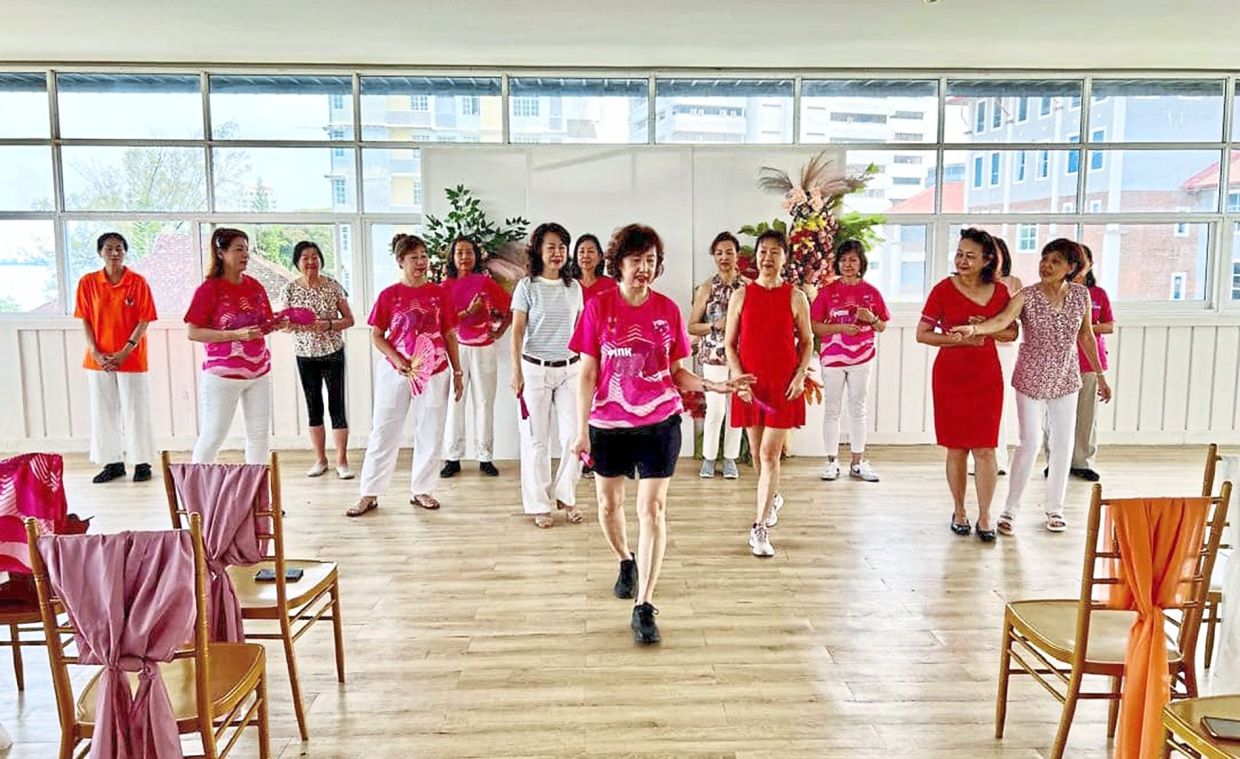 Members practising how to project grace and confidence when on the catwalk. 