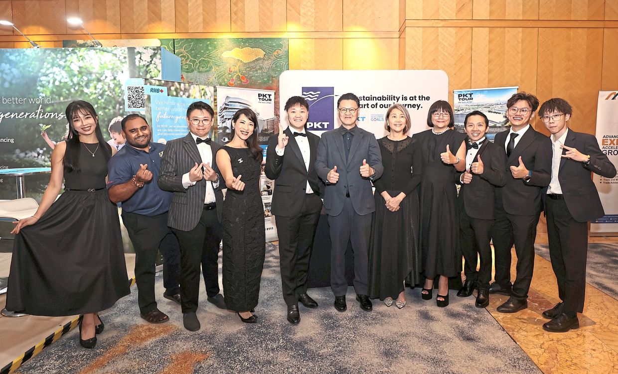 Tio (centre) with his team at the group’s booth. 