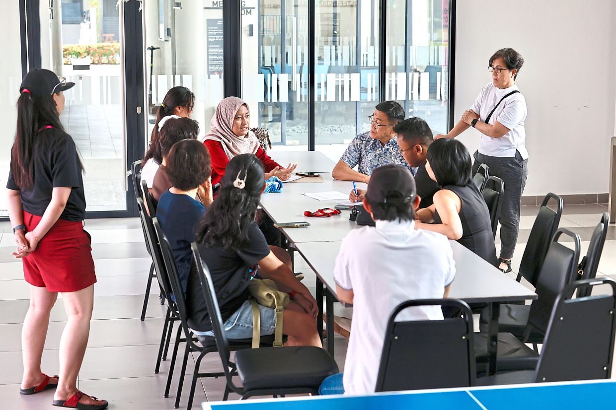 Affected residents airing their grievances during a meeting at Tropicana Aman Dalia Residences, in Telok Panglima Garang.