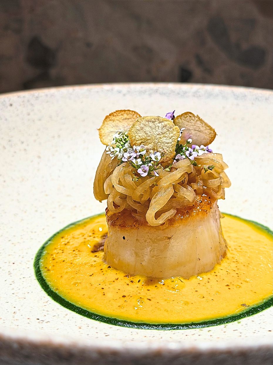Plump Japanese scallop is the star of this offering, which highlights successful flavour contrasts and precision cooking. — DC Restaurant