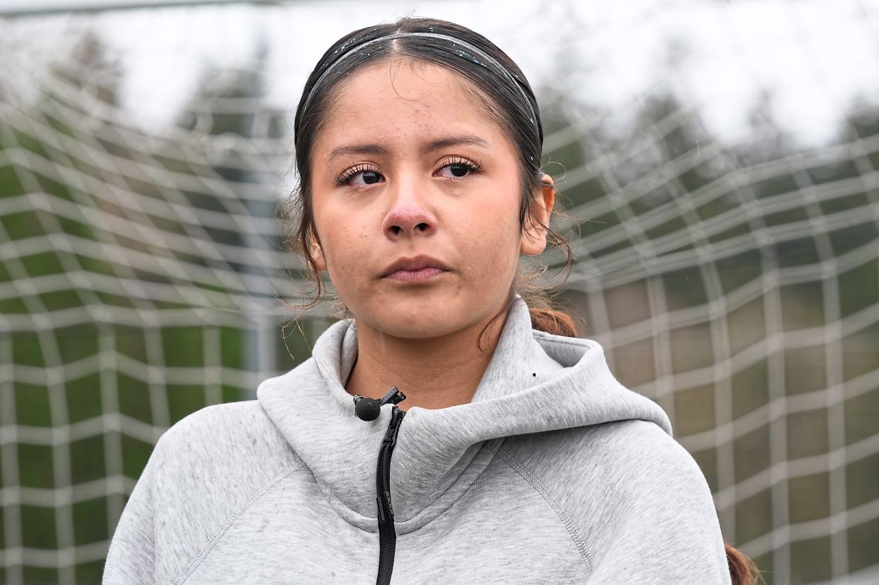 Valeria, whose brother was deported to Mexico late last year, tears up during an interview.