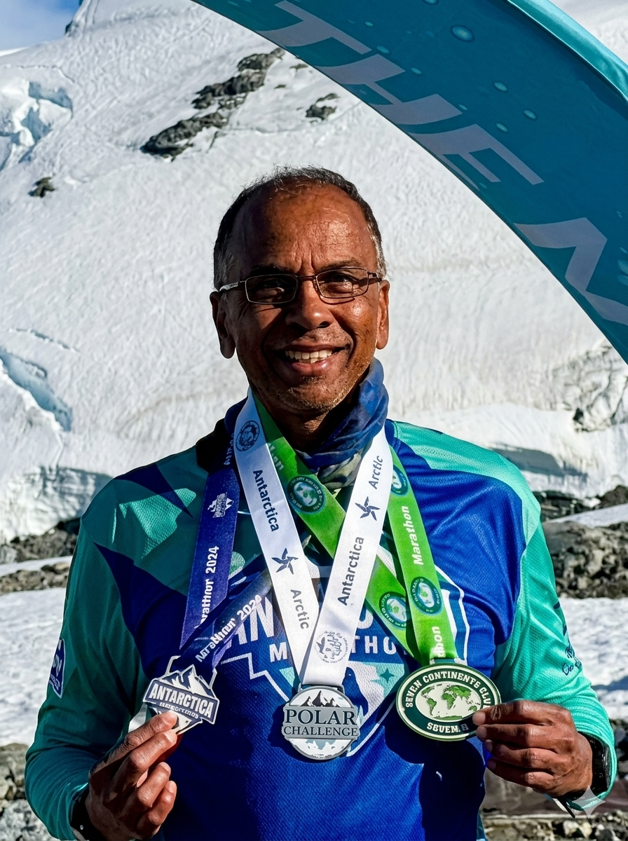 With his Antarctica Marathon finisher’s medal set against a backdrop of sea and floating icebergs.