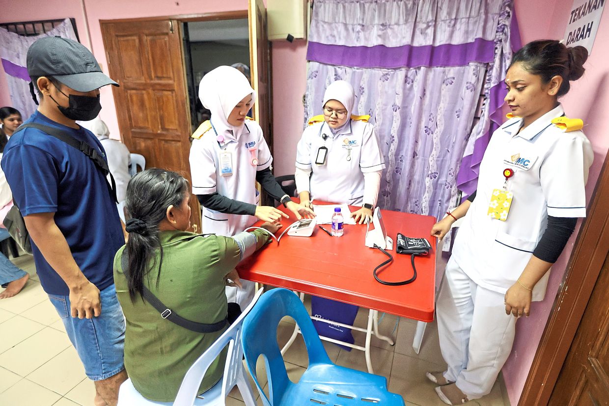 A resident having her blood pressure checked at the event organised by HELP University’s Rotaract Club and assisted by Rotary Clubs from Selangor and Kuala Lumpur.