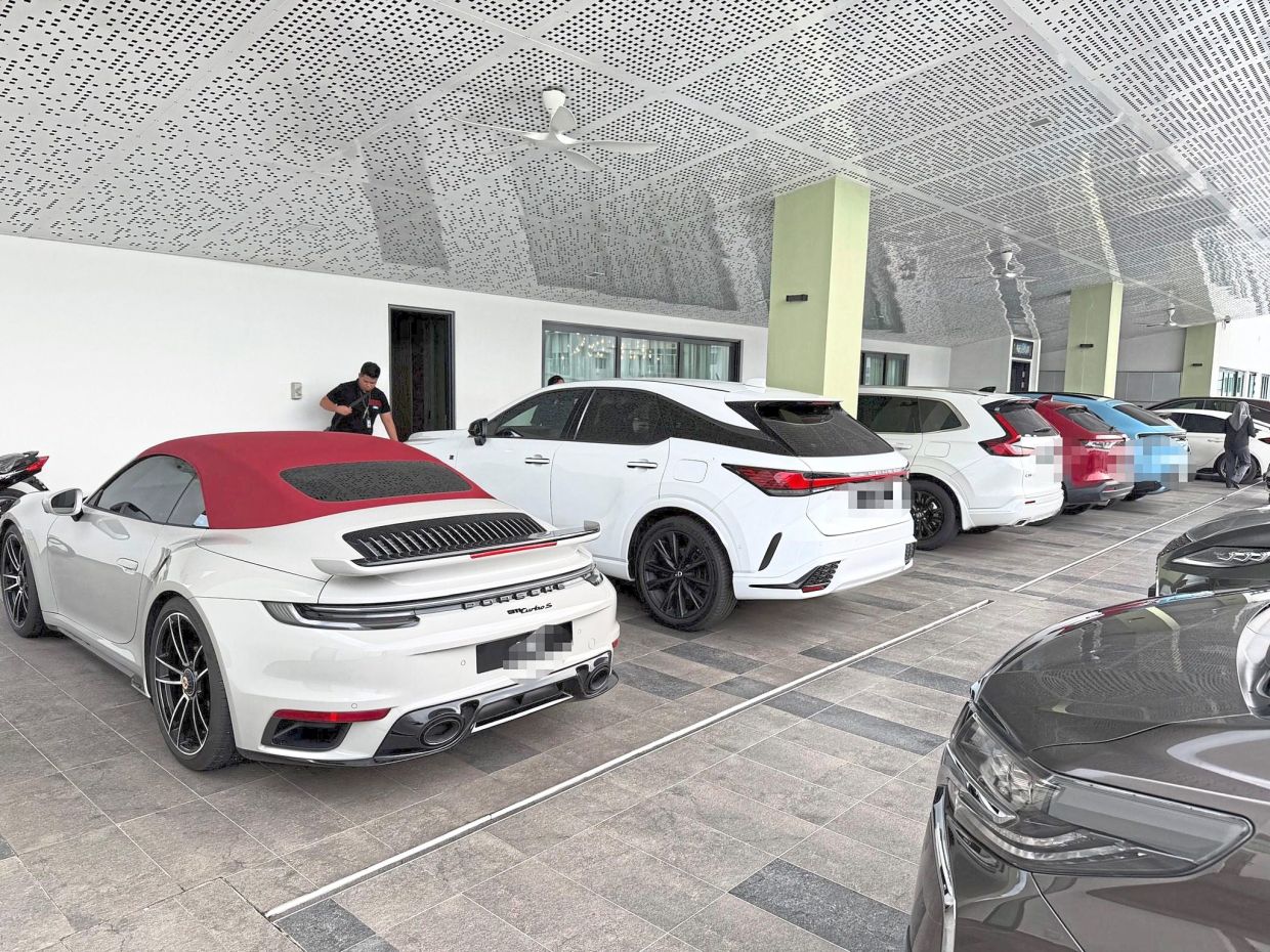 Under investigation: MACC seized 18 luxury vehicles as well as properties and houses valued at RM11mil, during an operation on April 21; (below) two men, including the deputy chairman of an NGO, are currently under remand to assist investigations. — MACC photo