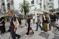Residents leave prayers and flowers on third day of return to Wang Fuk Court