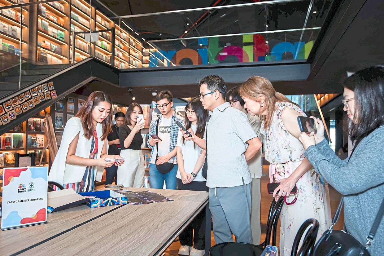 Kee (left) explains how the Emokins game works at its launch earlier this month. Photo: Kee Joey 