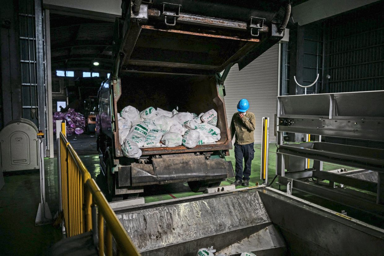 Nothing wasted: A worker handling recycled diapers in a recycling facility in Osaki town, Kagoshima prefecture. – AFP