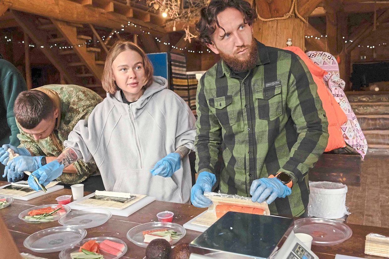 Podobailo (left) and Yasineko at a sushi-making class during the 10-day 'Repower' retreat for medics like themselves.