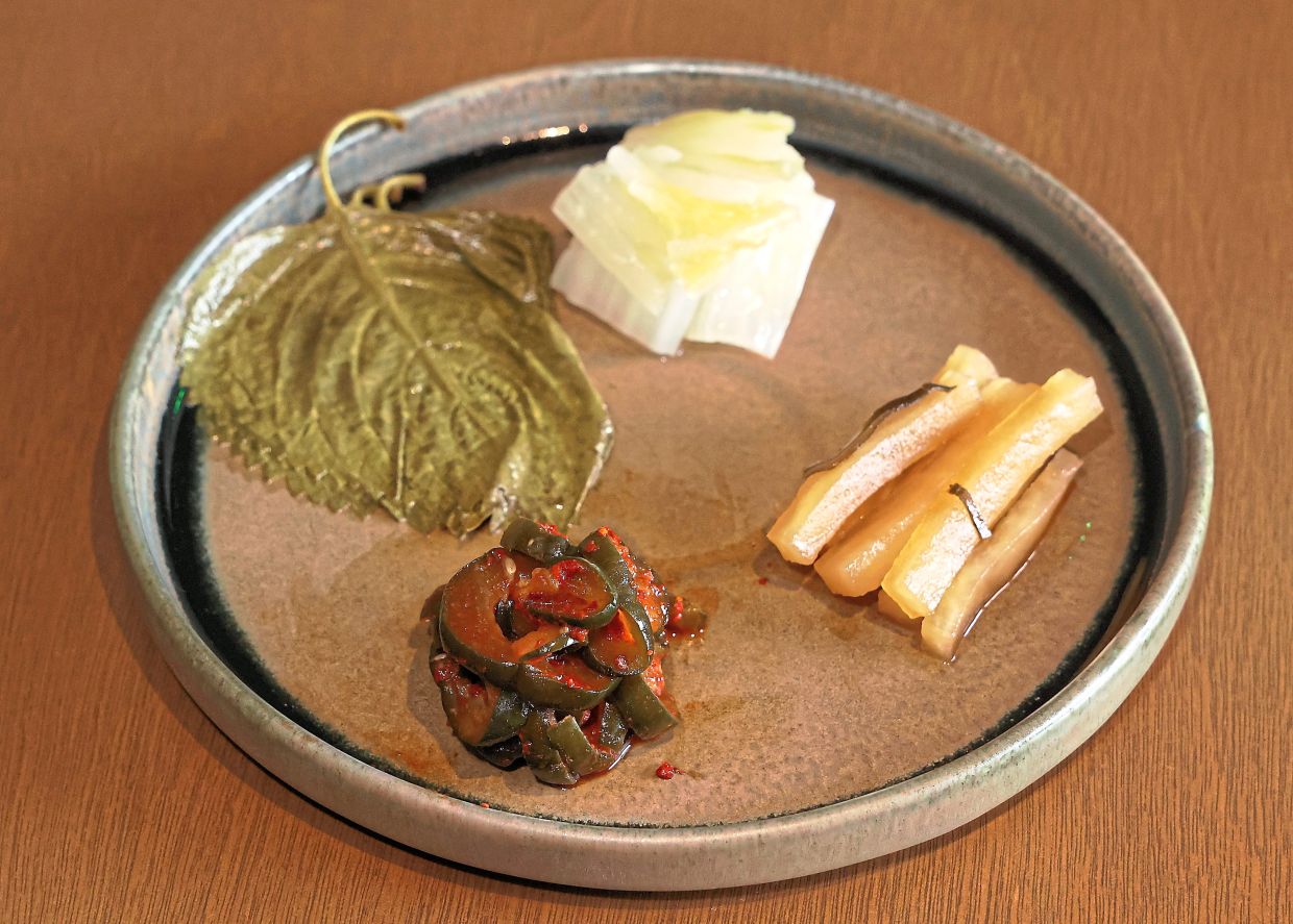 House-made pickled vegetables are a great way to start a meal at Tobon. — ART CHEN/The Star