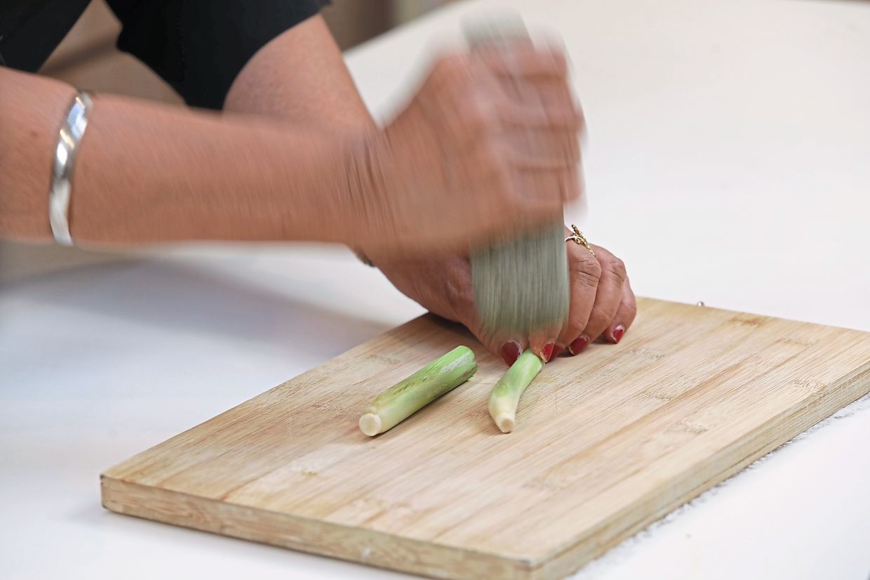 Steps for making a flavourful everyday sardine dish include lightly bruising the lemongrass — SAMUEL ONG/The Star