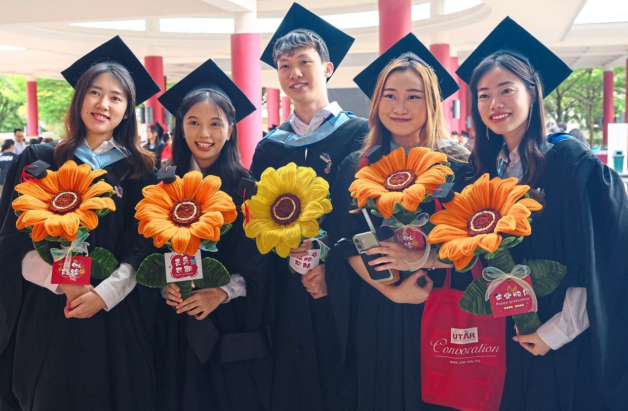 A moment to remember: Graduates posing for a celebratory photo.