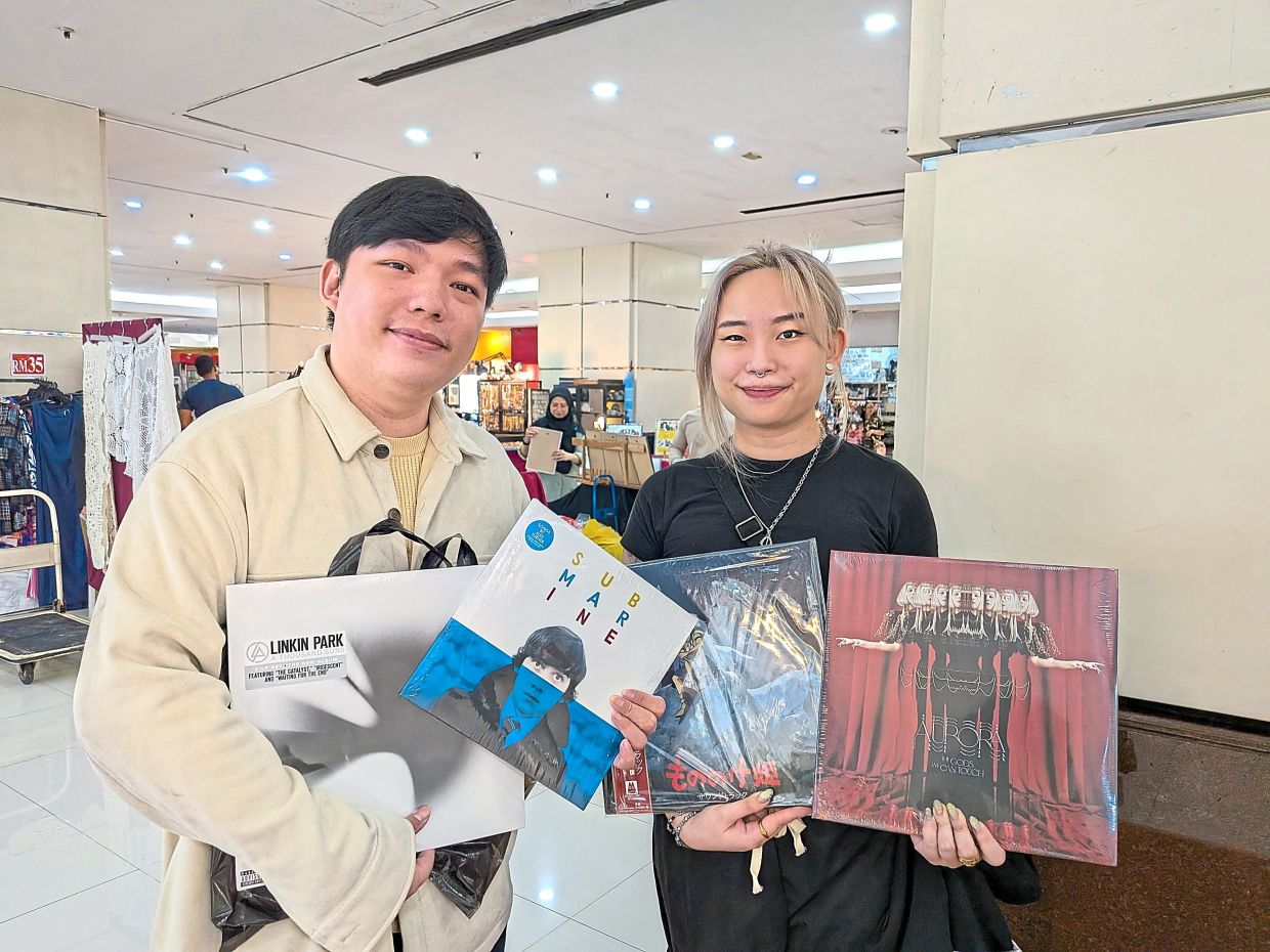 Bock (right) and Chan with a vinyl haul of old and new releases. — CHRISTOPHER FAM/The Star