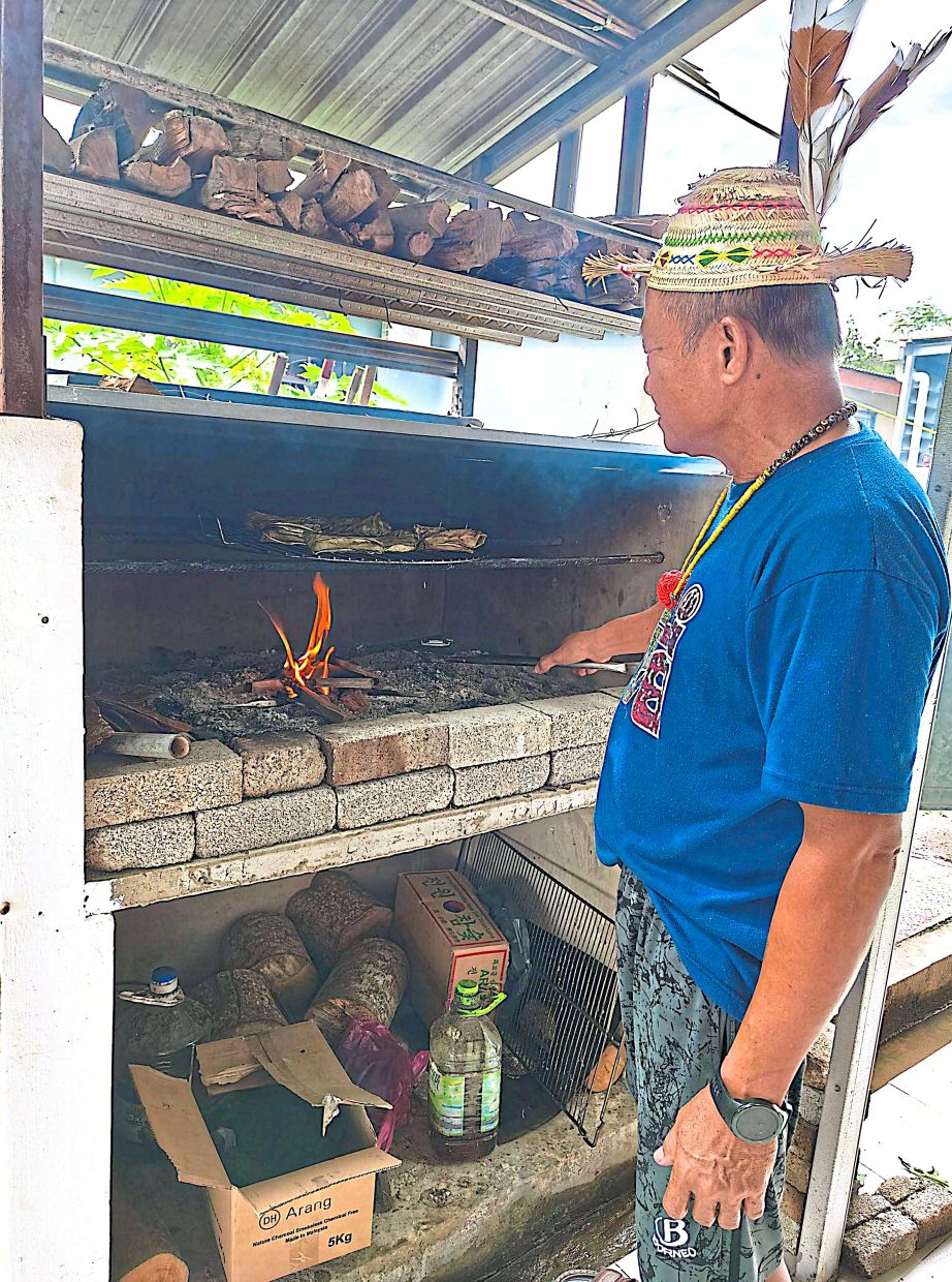 Hamilton smoking the wrapped durian to make ‘diking dian’.