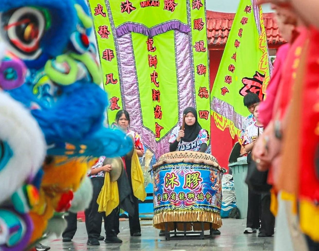 A Malay troupe member beating the drums during a performance.