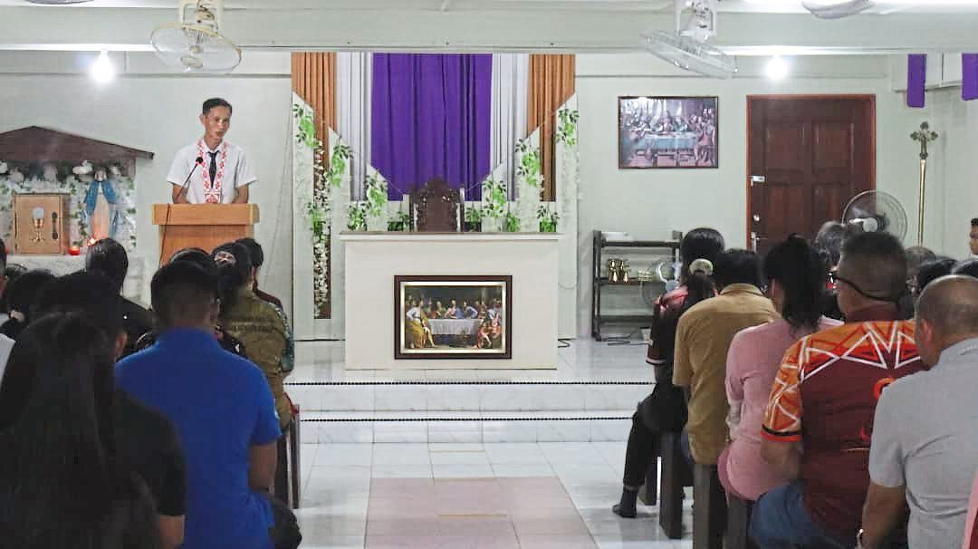 Belasius leading prayers inside the church.