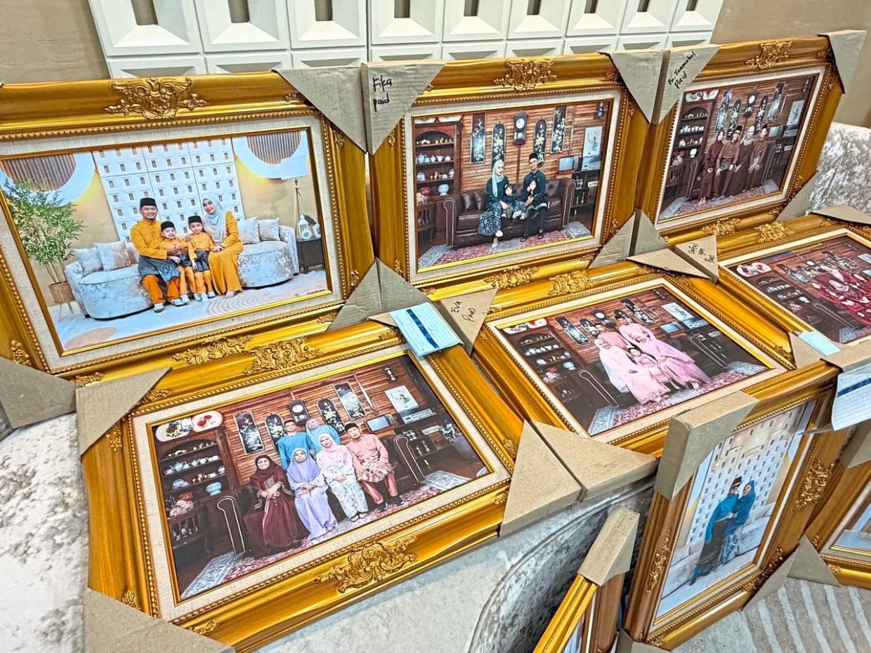 Framed Raya family portraits ready for collection at a local studio.