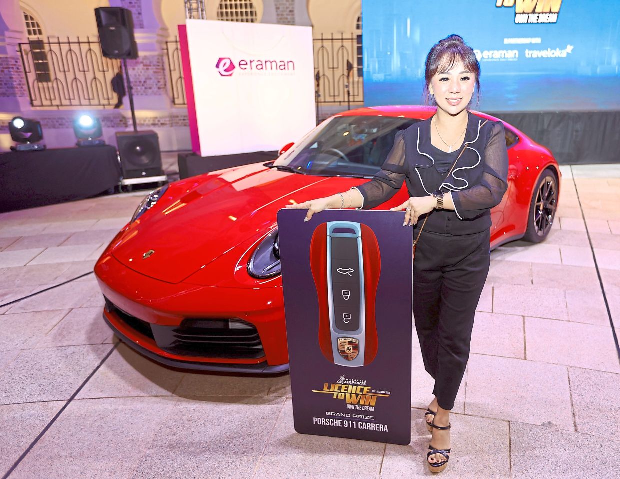 Raenita with the grand prize of Porsche 911 Carrera.