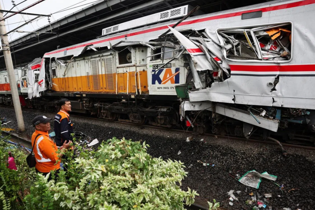 Technicians look on at the site after a deadly collision between a commuter line train and a long-distance train, in Bekasi, on the outskirts of Jakarta, Indonesia, on April 28. - Reuters
