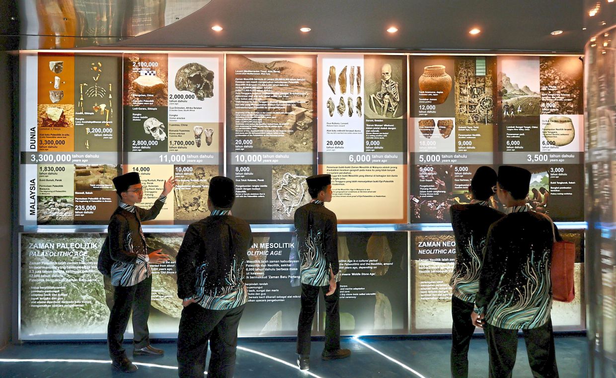 A group of students looking through informative exhibits at Guar Kepah Archaeological Gallery in Kepala Batas.