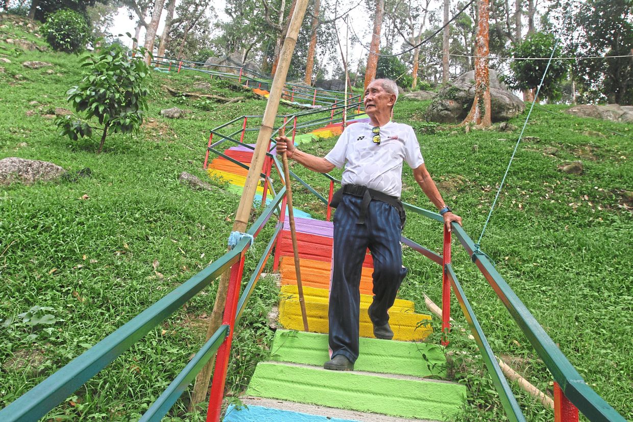 A hiker descending the iconic rainbow staircase at Berapit Hill. — Photos: LIM BENG TATT/The Star