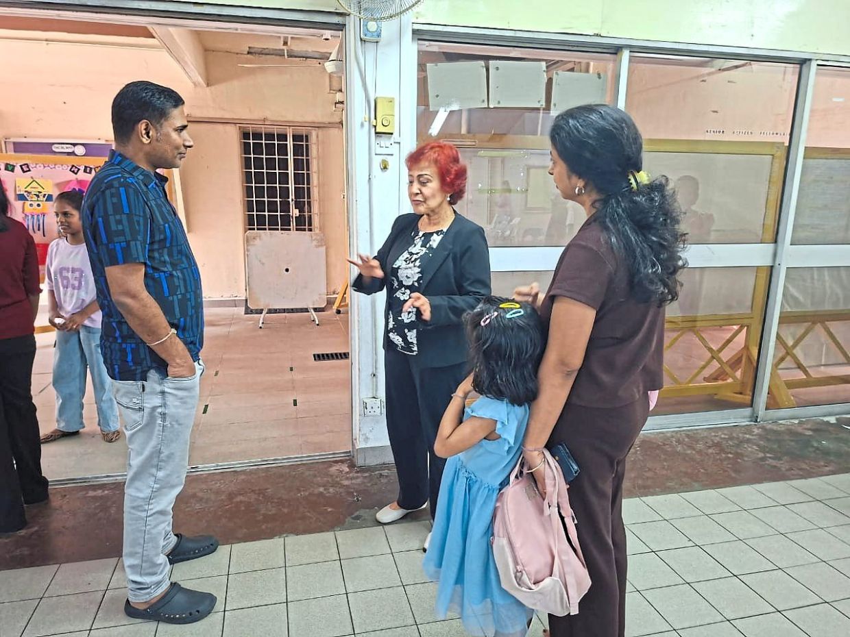 Patricia (centre) engaging with parents during the open day.