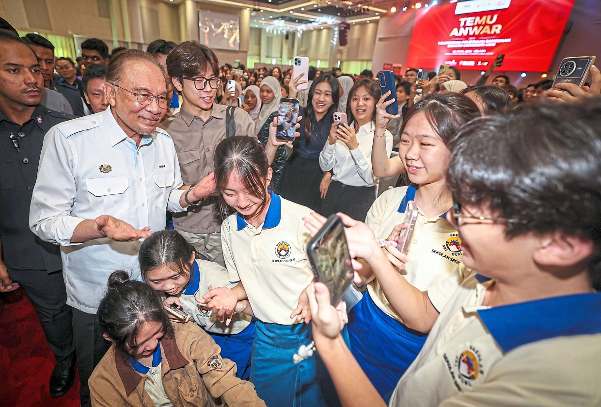 All smiles: Anwar engaging with students at the launch ceremony of UCSI’s campus expansion in Kuala Lumpur. — Bernama