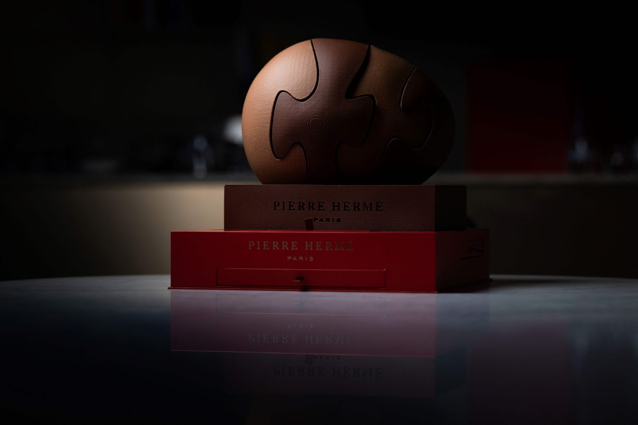 A creation by Pierre Herme, a chocolate egg inspired by the Mini Puzzle Stone by American sculptor Christopher Curtis.