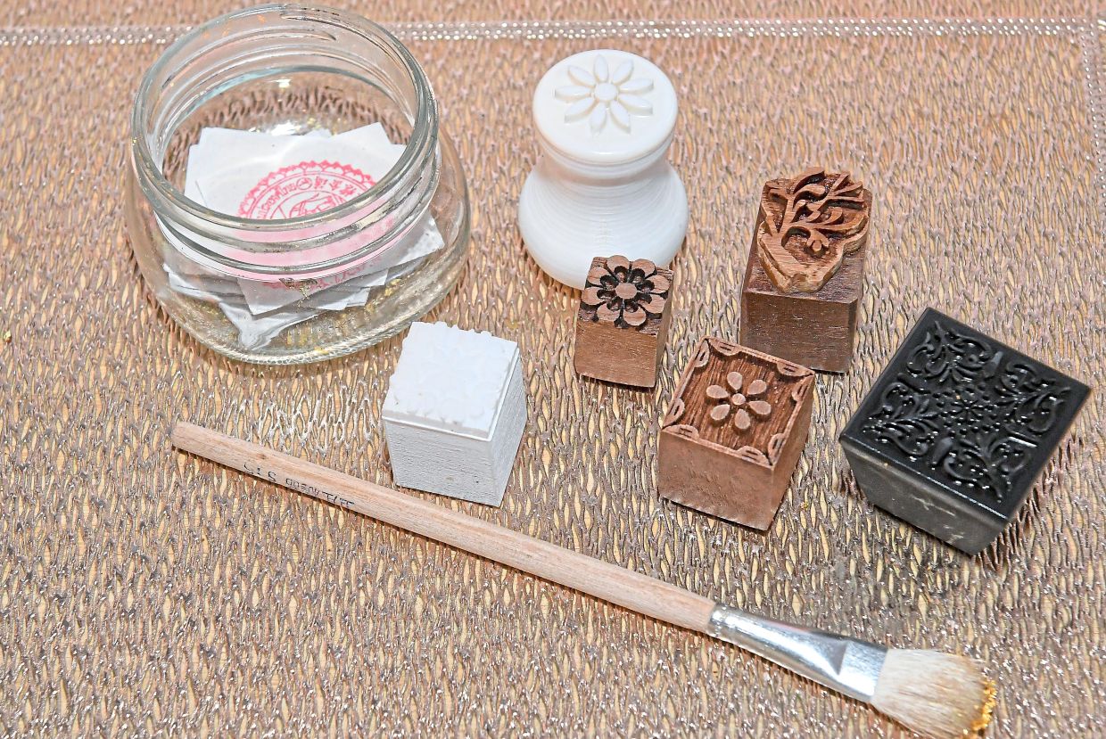 Carved stamps, gold leaf and brush used for the heritage fabric art.