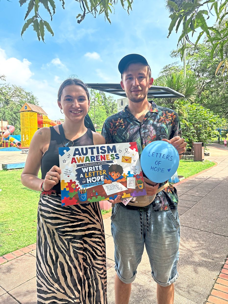 Members of the public sharing their message on the ‘Letters of Hope’ card for children with autism.