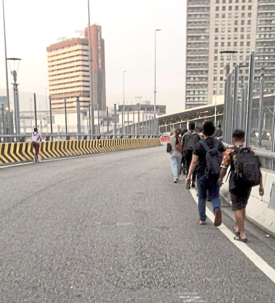 Some choose to walk across the Causeway into Singapore daily to save time. — Courtesy of C. Ravin