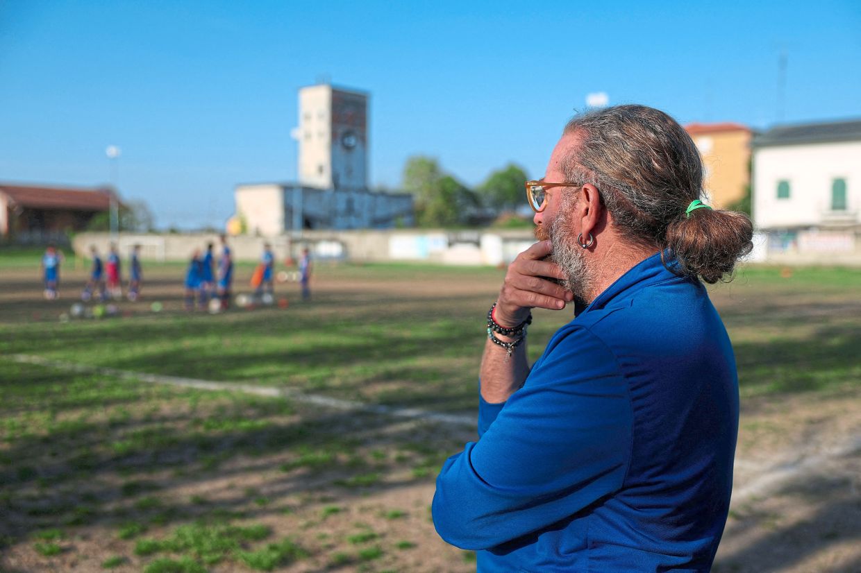 Di Franco looks on during his son Enrico's football session. Photo: Reuters