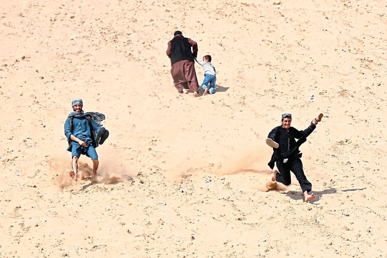 Hundreds of visitors travel each weekend to practise parkour or roll down the honey-coloured sand. Photo: AP
